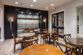 Houston apartment for rent - A room with a long table and chairs.