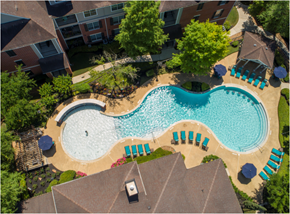 Katy apartment for rent - an aerial view of an outdoor swimming pool and poolside lounge chairs in a resort