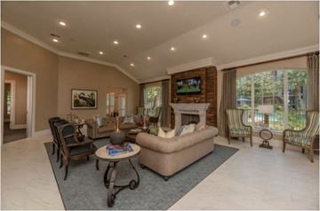 Kingwood apartment for rent - A living room with a fireplace and a television on the wall.