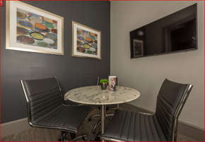 Houston apartment for rent - a small dining area with a table and chairs and a television