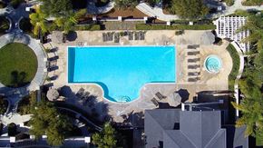 Carlsbad apartment for rent - An aerial view of a swimming pool surrounded by buildings and trees.