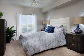 Carlsbad apartment for rent - A bedroom with a large bed and a ceiling fan.