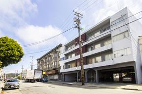San Francisco apartment for rent - A street view of a residential area with cars and buildings.
