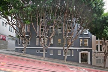 San Francisco apartment for rent - A grey building with trees in front of it.