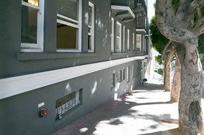 San Francisco apartment for rent - A tree is next to a building with a red light on it.