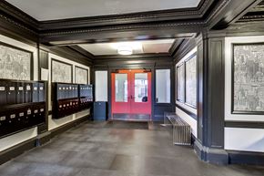 San Francisco apartment for rent - A room with a red door and pictures on the wall.