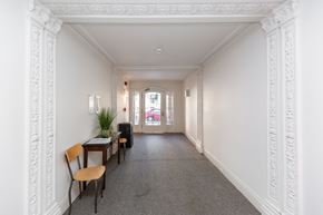 San Francisco apartment for rent - A long white hallway with a table and chairs on the left side.