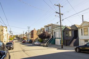 San Francisco apartment for rent - A street view of a residential area with cars parked on the side of the road.