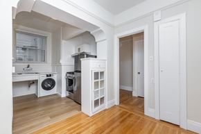 San Francisco apartment for rent - A white kitchen with a washer and dryer in it.