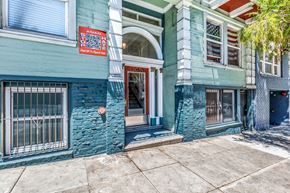 San Francisco apartment for rent - A blue building with a red sign that says "Asian Spirits" on it.