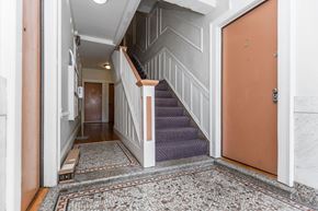 San Francisco apartment for rent - A hallway with a staircase and a door.
