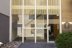 San Francisco apartment for rent - A modern house entrance with a glass door and a wooden slatted awning.
