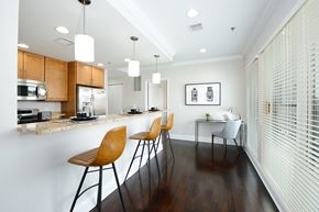 Hoboken apartment for rent - a kitchen with a long counter with three stools