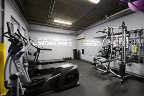 Hoboken apartment for rent - a gym with various exercise equipment and a wall saying dont misuse it work fort