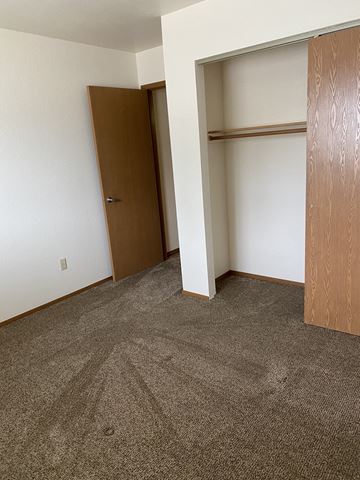 Columbia Falls apartment for rent - a bedroom with a closet and a carpeted floor