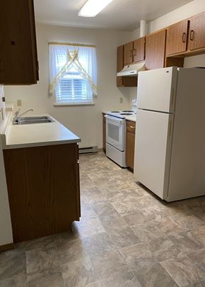 Columbia Falls apartment for rent - Image of refrigerator, stove, sink, cabinets, and window