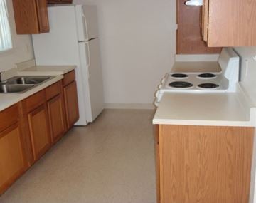 Columbia Falls apartment for rent - a kitchen with a stove and a sink and a refrigerator
