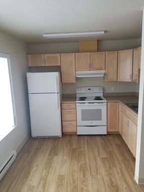Kalispell apartment for rent - Image of refrigerator, stove, range hood, cabinets and sink