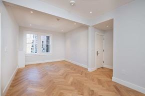 Cambridge apartment for rent - an empty living room with a wooden floor and a window