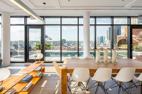 Jersey City apartment for rent - a dining room with a table and chairs and a view of the city