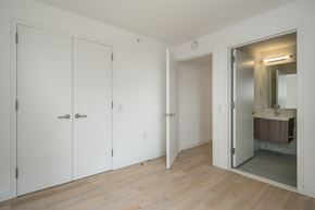 Jersey City apartment for rent - a bedroom with white closets and a bathroom with a mirror