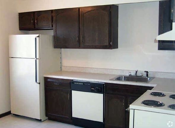 Henrietta apartment for rent - a kitchen with a white stove and a refrigerator