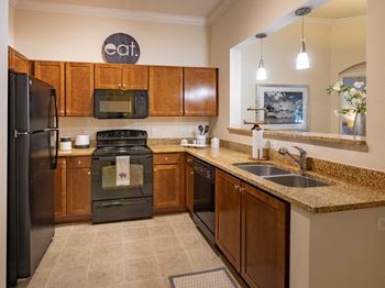 Fully-equipped kitchen with dishwasher, disposal, fridge, and microwave