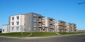 Dickinson apartment for rent - Image of exterior of building, lawn, and road passing by