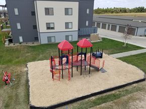Dickinson apartment for rent - Image of playground in sand on one end of the building