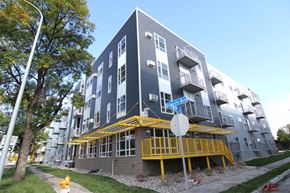 Grand Forks apartment for rent - a tall apartment building with a street sign in front of it