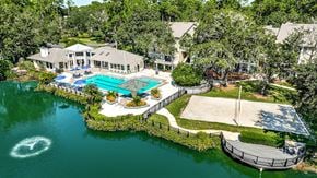 Jacksonville apartment for rent - an aerial view of a mansion with a swimming pool and a pool house and a