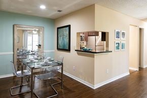 Jacksonville apartment for rent - a dining room with a glass table and chairs