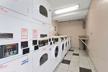 A laundry room with washers and dryers