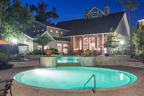 The Woodlands apartment for rent - a swimming pool with a house in the background