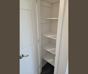 Anchorage apartment for rent - A white door is open to a pantry with shelves.