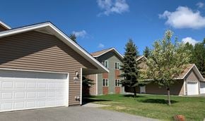 Anchorage apartment for rent - a home with a white garage door in front of two houses