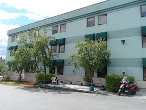 Anchorage apartment for rent - a building with a scooter parked in front of it