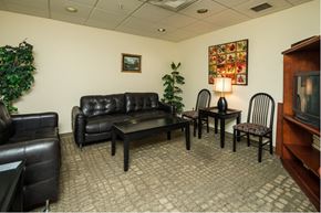 Anchorage apartment for rent - a living room with leather furniture and a television