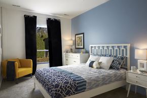 Madison Heights apartment for rent - A bedroom with a bed, nightstand, and chair.