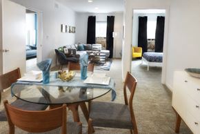 Madison Heights apartment for rent - A modern dining room with a glass table and chairs.