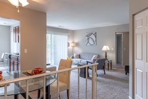 Arlington Heights townhouse for rent - A modern dining room with a glass table and chairs.