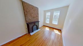 Jersey City apartment for rent - A room with a fireplace and wood flooring.
