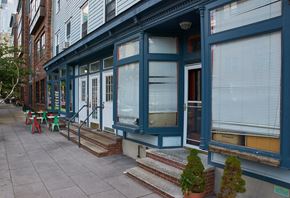 Jersey City apartment for rent - A blue building with a red door and steps leading up to it.
