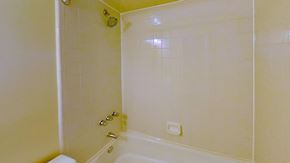 Jersey City apartment for rent - A white bathroom with a shower and a toilet.