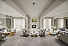 Jersey City apartment for rent - A modern living room with a fireplace and grey sofas.