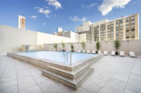 Jersey City apartment for rent - A large outdoor swimming pool with steps leading into it.