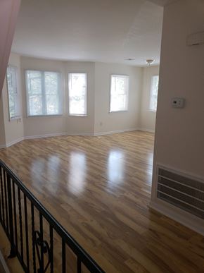 Jersey City apartment for rent - A room with wooden floors and a window.