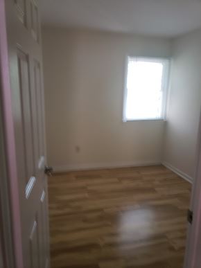 Jersey City apartment for rent - A room with a wooden floor and a window.