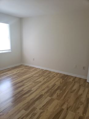 Jersey City apartment for rent - A room with wooden flooring and a window.