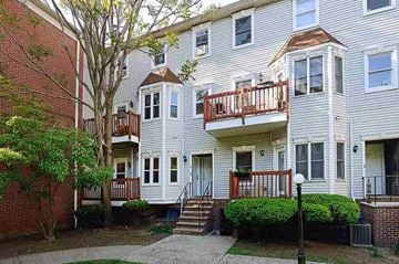 Jersey City apartment for rent - A white apartment building with a red brick building next to it.
